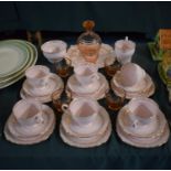 A Collection of Pink Vogue Teawares to Comprise Six Trios, Cake Plate, Sugar and Cream Together with