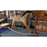 A Vintage Straw Filled Plush Rocking Horse, 77cm to the Top of Ear