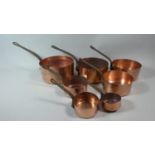 A Graduated Set of Seven Copper Saucepans with Iron Handles