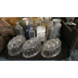 A Tray Containing Various Glass Jars and Bottles, Glass Jelly Moulds etc