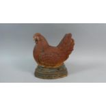 A Painted Cast Metal Door Stop in the Form of a Chicken, 23cm High