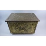 A Beaten Brass Slipper Box Decorated in Relief with Tavern Scenes, 46cm Wide