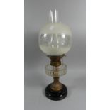 A Late Victorian Brass Mounted Oil Lamp with Glass Reservoir Globe and Chimney, 53cm High