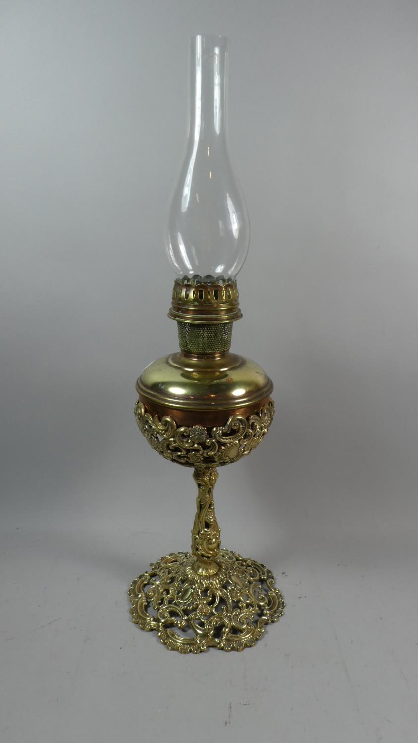 A Late 19th Century Brass Oil Lamp with Pierced Support and Reservoir Holder, Complete with Glass