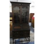 An Edwardian Oak Bureau Bookcase with Two Short and One Long Drawers Barley Twist Supports and