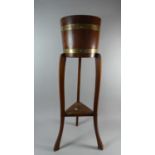 An Edwardian Brass Banded Oak Circular Topped Planter on Tripod Support with Stretcher Shelf, 91cm