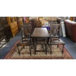 An Oak Gate Leg Barley Twist Drop Leaf Dining Table with Oval Top Together with Four Oak Framed