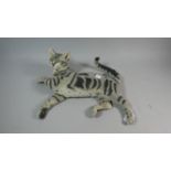 A Resin Study of a Reclining Cat, 42cm Long