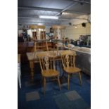 A Pine Rectangular Kitchen Table with Six Chairs