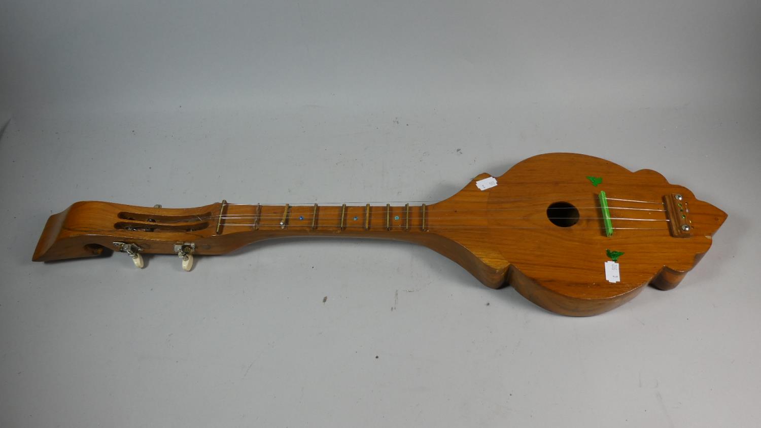 A Wooden Four String Musical Dulcimer