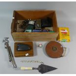 A Box of Curios to Include Leather Cased Tape Measure, Commemorative Trowel, Music Stand,