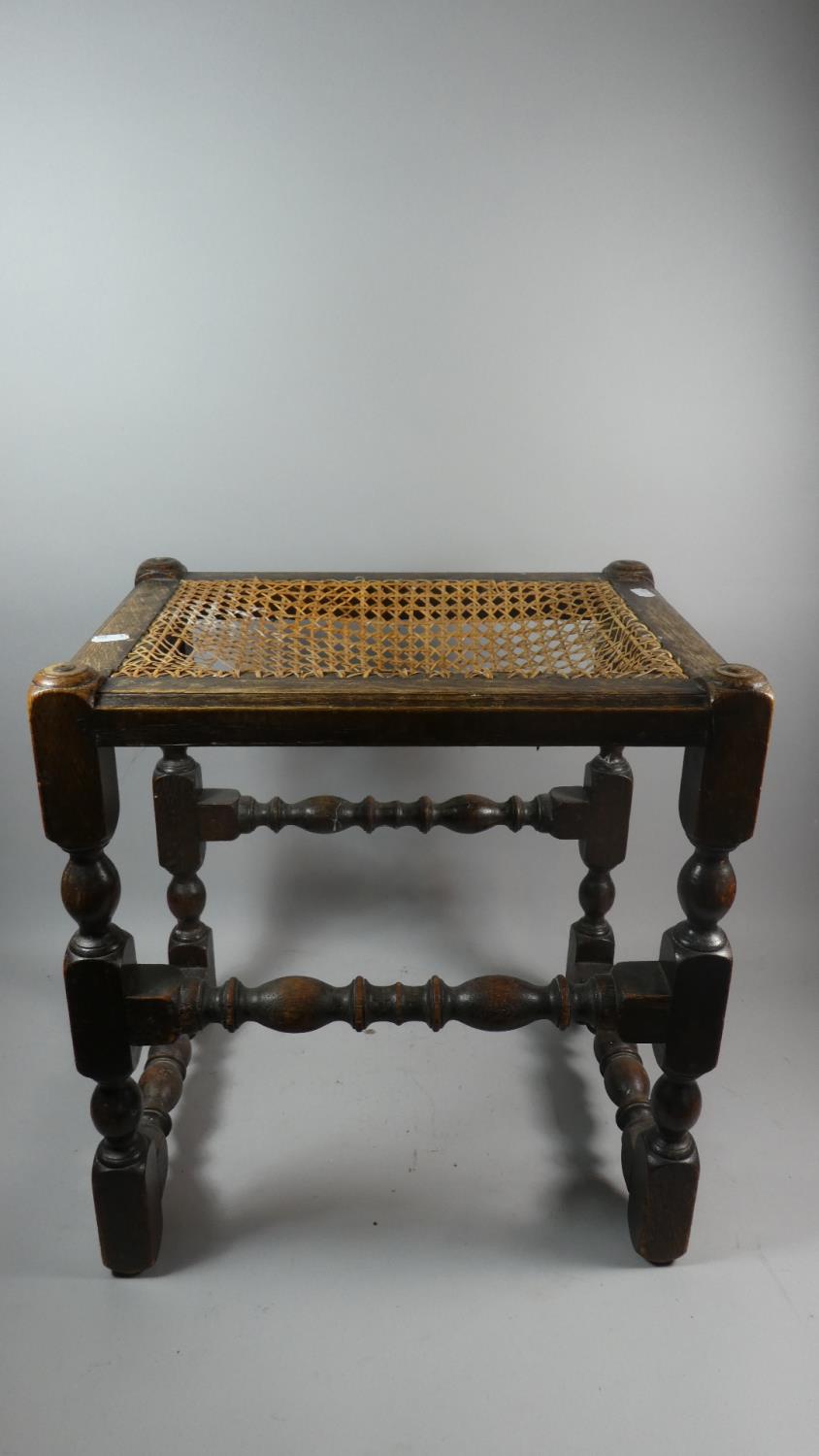 An Edwardian Oak Framed Cane Top Stool in Need of Attention, 44cm Wide
