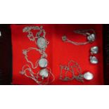 A Collection of Seven Heart Shaped and Oval Silver Lockets and Chains