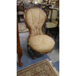 A Victorian Walnut Framed Circular Seated Ladies Balloon Back Nursing Chair on Cabriole Supports