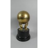 A Brass Sporting Trophy in the Form of a Globe Supported by Two Hands, 33cm High