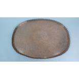 A North African Copper Tray with Engraved Decoration in the Paisley Style, 39cm Wide