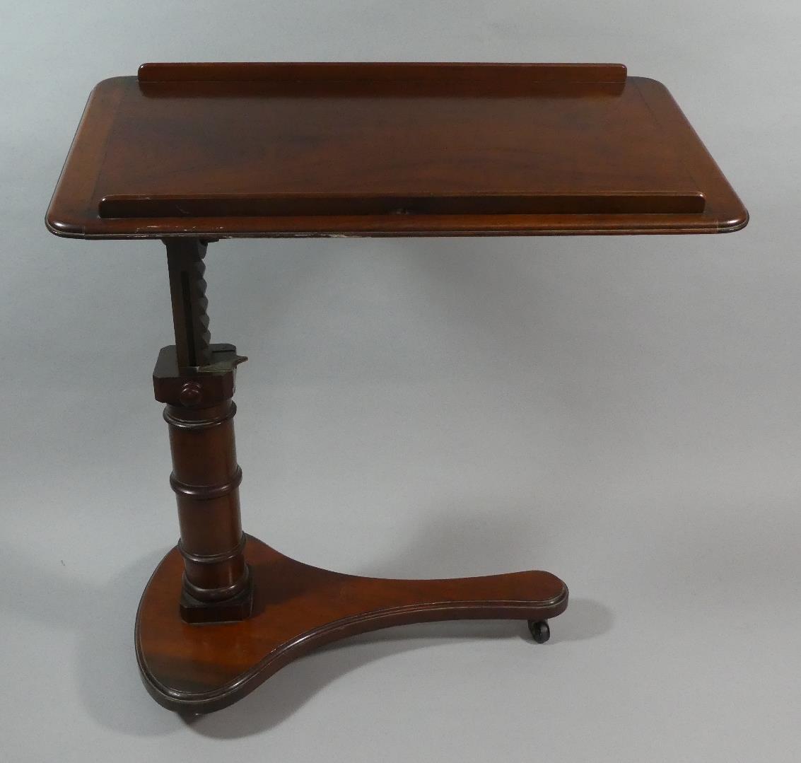 A Victorian Mahogany Adjustable Music Stand with Turned Support and Rise and Fall Mechanism.