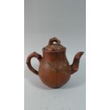 An Oriental Lobed Yixing Teapot with Blossom Decoration in Relief to Body and Lid. Impressed Seal