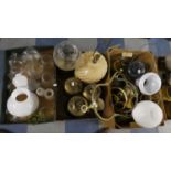 Two Boxes Containing Seven Various Brass Oil Lamps, Glass Shades, Chimneys, Hurricane Lamp etc