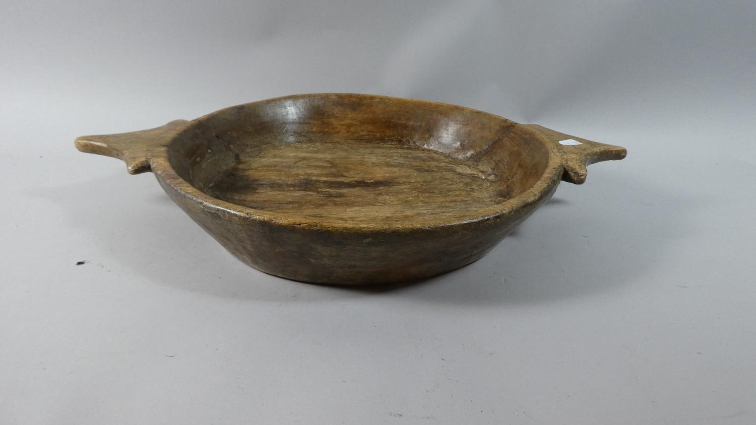 A Tribal Carved Wooden Two Handled Bowl, 36cm Diameter