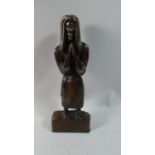 A Carved Wooden Tribal Figure of Standing Man Praying, 35cm High