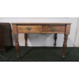 An Edwardian Oak Writing Table with Tooled Leather Top and Two Drawers, Turned Supports