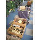 A Shopping Trolley Together with Two Boxes of Sundries to Include Bread Boards, Shoe trees,