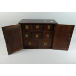 A 19th Century Colonial Spice Chest with Pierced Panelled Doors to Eight Inner Drawers with Flush