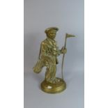A Figural Brass Door Stop in the Form of Caddy Carrying Golf Bag and Clubs and Holding Flag, 38cm