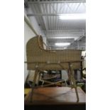 A Wicker Moses Basket on Bamboo Stand