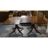 A Mahogany Twin Pedestal Extending Dining Table with One Extra Leaf