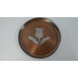 An Inlaid Circular Copper Tray Decorated with white metal Thistle, Monogrammed for Hugh Wallis, 18cm