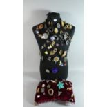 A Tailers Torso Dummy with Large Quantity of Costume Jewellery Brooches Together with a Red Velvet