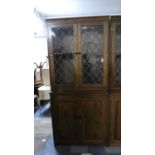 A Mid 20th Century Lead Glazed Library Bookcase with Crossbanded Panelled Doors to Cupboard Base,