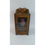 An Edwardian Oak Smokers Box with Glazed Door to Fitted Interior with Pipe Rack and Drawer,