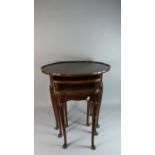 A Nest of Three Mahogany Oval Topped Pie Crust Tables, the Largest 60cm Wide