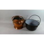 A Copper Helmet Shaped Coal Scuttle and an Enamelled Metal Jam Pan with Loop Handle