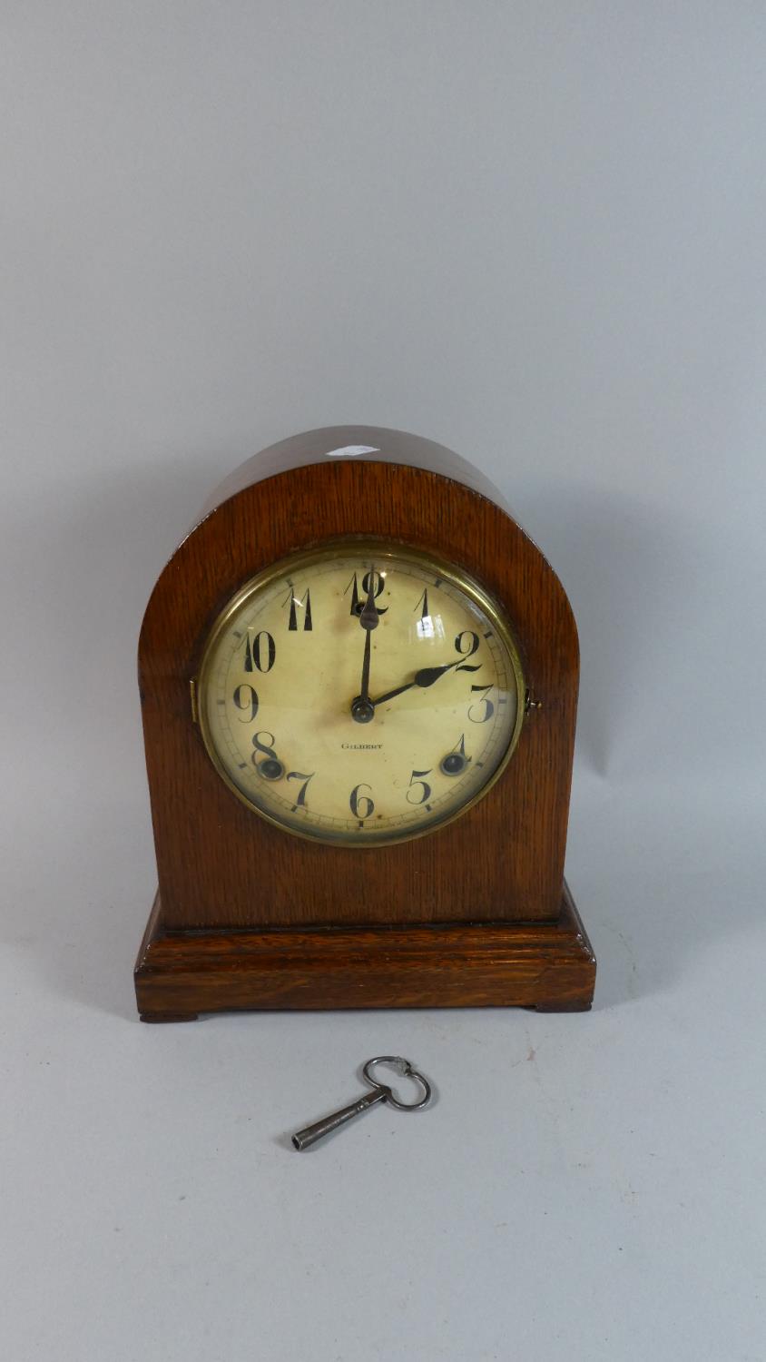 An Edwardian Oak Cased Dome Topped Mantle Clock, the Dial Signed Gilbert, Eight Day Movement, 27cm