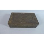 A Chinese Bronze Effect Box Decorated in Relief with Dragons Chasing the Flaming Pearl, Birds and