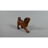 A Carved Wooden Netsuke in the Form of a Dog, 4cm High