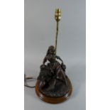 A Modern Bronze Effect Figural Table Lamp in the Form of Girl Seated on Sheaves of Corn with Two