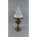 A Brass Oil Lamp with Opaque Glass Shade and Chimney, 62cm High