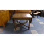 An Oak Barley Twist Drop Leaf Dining Table with X Stretcher