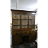 An Edwardian Oak Dresser with Glazed Shelf Top Section, Three Centre Drawers, Open Base Display