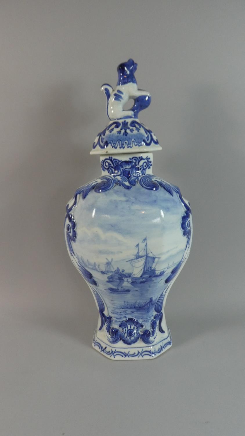 A Large Blue and White Delft Vase and Cover Decorated with River Scene, Lion Finial, 43cm High