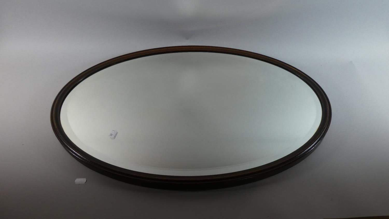 An Edwardian Oval Oak Framed Wall Mirror with Bevelled Glass, 75cm Wide