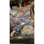 A Box Containing Fifteen Bags of Costume Jewellery