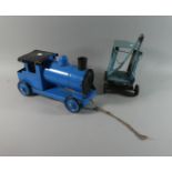 A Child's Pull Along Tin Plate Locomotive and a Crane