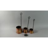 A Set of Three Graduated Brass Mounted Copper Cider Warmers with Iron Handles