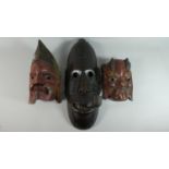 A Collection of Three Carved Tribal and Ethnic Masks